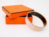 an orange box with a pink and gold bracelet inside of it