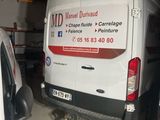 a van that is parked in a garage next to another van