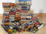 a lot of toy cars and trucks that are on the floor