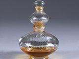 a clear glass bottle with a brown liquid inside of it