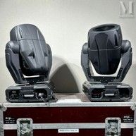 two moving lights sitting on top of a case