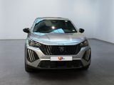 the front view of a silver car parked in a showroom