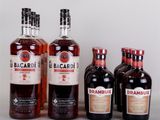 four bottles of alcohol are lined up on a table