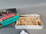 a box with a model of a car in it and a box with a model of a car in it