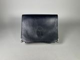 a black leather wallet sitting on top of a white table
