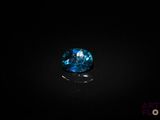 a close up of a blue diamond on a black surface