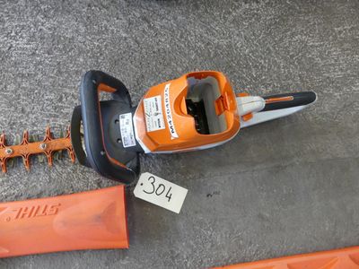 a chainsaw that is laying on the ground with a price tag on it