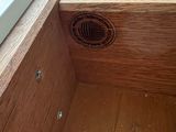 a wooden box with a hole in the middle of it