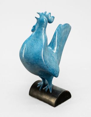 une sculpture bleue représentant un oiseau, posée sur un socle noir