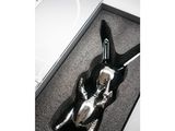 a silver spoon in a black box with a black handle