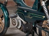 a close up of a green motorcycle parked in a garage