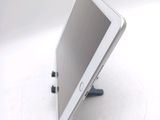 a tablet computer sitting on a stand on a white surface