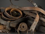 a pile of old belts and other items on a table
