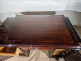 an image of a wooden desk with drawers underneath it