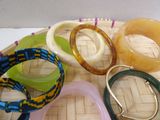 a lot of different bracelets and bangles on a tray