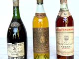 three bottles of liquor sitting on a marble table
