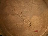 a close up of a brown pot with writing on it
