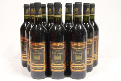 six bottles of wine are lined up in a row on a white surface