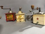 five different types of coffee grinders on a table