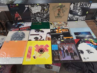 a lot of vinyl records on a table in a room