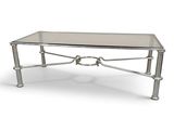 une table basse argentée avec un plateau en verre et des pieds en métal