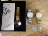 a box with a watch and other items on a table
