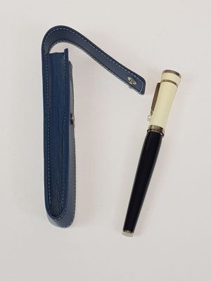 an image of a pen and a pen holder on a white surface