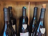 several bottles of wine are lined up in a wooden box