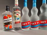 several bottles of alcohol are lined up on a table