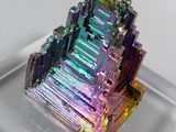 a very colorful piece of crystal on a clear plate