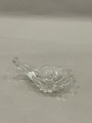 a glass bowl with a spoon in it sitting on a table