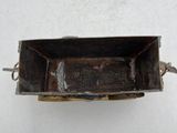 an old metal tray with a handle on a white surface