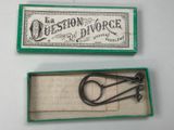 two pairs of scissors in a box with a label on it