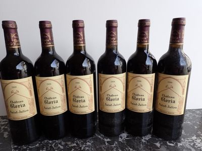 six bottles of wine are lined up in a row on a table