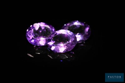trois améthystes violettes sur un fond noir