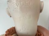 a person holding a clay head in their hand