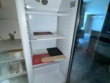 an open refrigerator that is sitting in the middle of a room