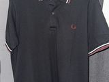 a black polo shirt with a red and white stripe on the collar