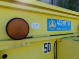 a yellow dump truck with a sign on it