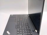 a laptop with a black keyboard on a white surface