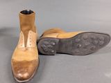 pair of men ' s brown leather boots with brown soles