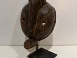 an image of a wooden sculpture of a bird on a stand