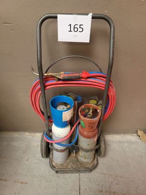 un chariot sur lequel sont posées des bouteilles de gaz et des tuyaux