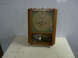 a small clock sitting on a table in a room