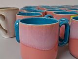 several cups are lined up in a row on a table