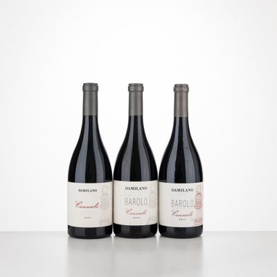 three bottles of red wine are lined up on a table