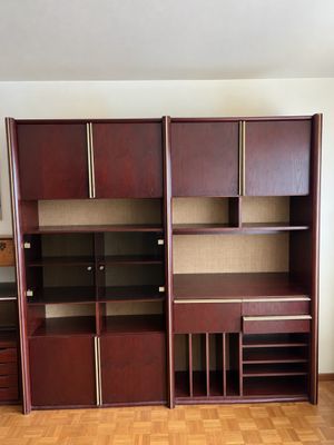 an empty room with a desk, shelves, and cabinets