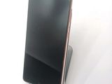 a cell phone that is sitting on top of a stand