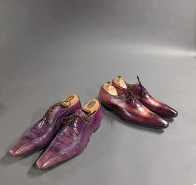 two pairs of purple shoes sitting on top of a table