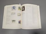 an open book with drawings on it on a table